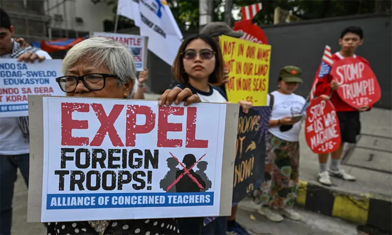 A PROTESTER holds up a sign during a demonstration in Quezon City, Philippines, against the joint
military exercises.—AFP A PROTESTER holds up a sign during a demonstration in Quezon City, Philippines, against the joint
military exercises.—AFP