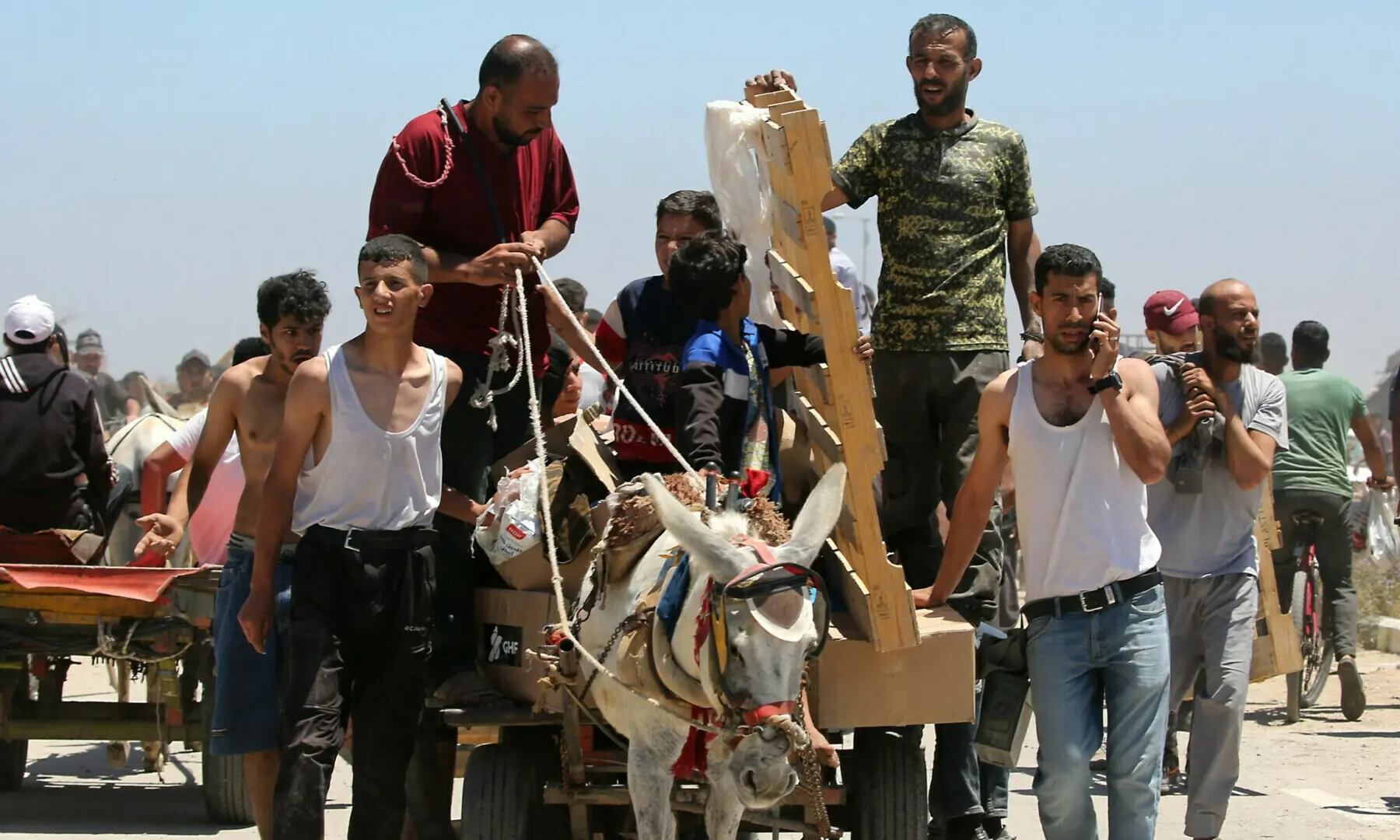 Displaced Palestinians carrying relief supplies return from an aid distribution centre in the central Gaza Strip on May 29, 2025. — AFP/File Displaced Palestinians carrying relief supplies return from an aid distribution centre in the central Gaza Strip on May 29, 2025. — AFP/File