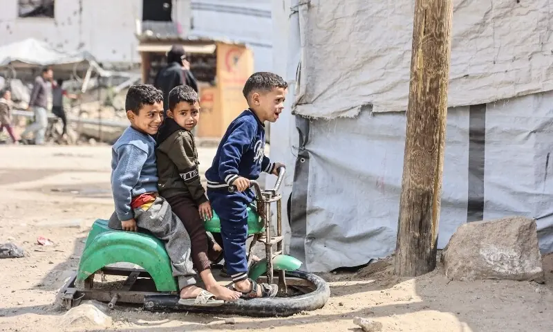 Palestinian children play on a street in Gaza City on April 20. &mdash; AFP