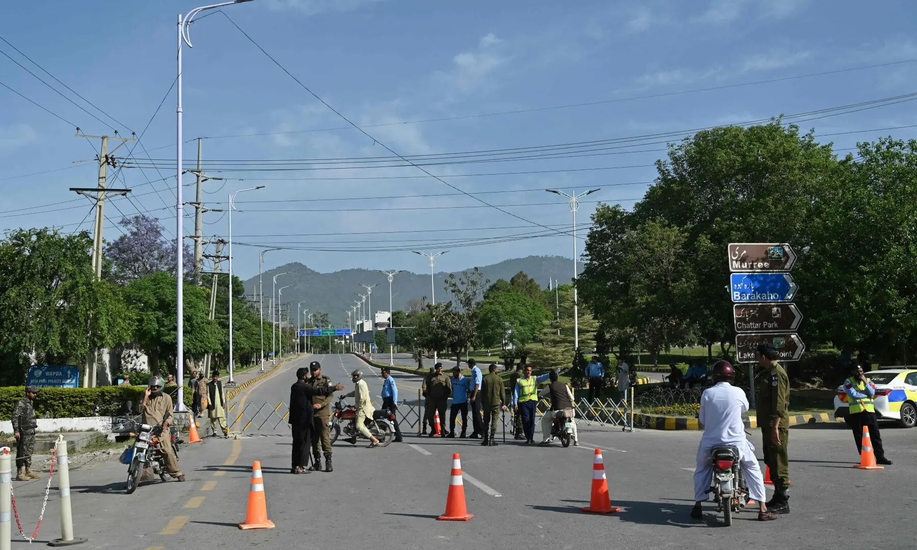 Security personnel guide commuters to alternate routes from a checkpoint near the Serena Hotel in Islamabad&rsquo;s Red Zone on April 21, 2026, amid heightened security measures ahead of possible US-Iran peace talks. &mdash; AFP