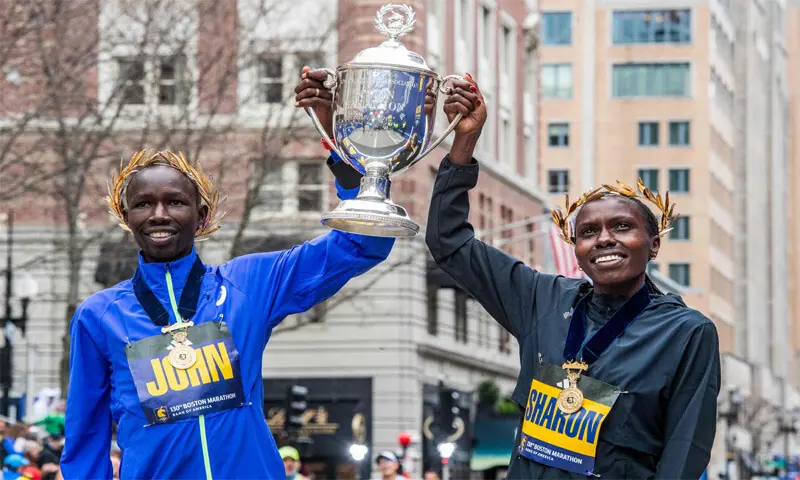 KENYA&rsquo;S John Korir (L) and Sharon Lokedi lift the Boston Marathon trophy after winning in the men&rsquo;s and women&rsquo;s divisions.&mdash;AFP
