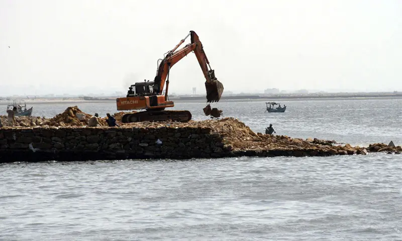 Heavy machinery is being used to reclaim land from the sea, a process which has serious impacts on the coastal ecosystem.—Online Heavy machinery is being used to reclaim land from the sea, a process which has serious impacts on the coastal ecosystem.—Online
