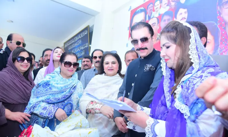 AJK’s former deputy speaker and PPP women’s wing regional president Shaheen Kousar Dar fills out a membership form as PM Faisal Mumtaz Rathore, BISP chairperson Senator Rubina Khalid and other participants look on at a function in Muzaffarabad on Tuesday. — photo by author AJK’s former deputy speaker and PPP women’s wing regional president Shaheen Kousar Dar fills out a membership form as PM Faisal Mumtaz Rathore, BISP chairperson Senator Rubina Khalid and other participants look on at a function in Muzaffarabad on Tuesday. — photo by author