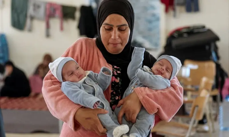 Ghada Mohammed Fadel, a displaced mother who fled her house after an Israeli evacuation order, holds her twin babies Mohammed and Mehdi, inside a university-turned shelter in Sidon, Lebanon, April 13. —Reuters Ghada Mohammed Fadel, a displaced mother who fled her house after an Israeli evacuation order, holds her twin babies Mohammed and Mehdi, inside a university-turned shelter in Sidon, Lebanon, April 13. —Reuters