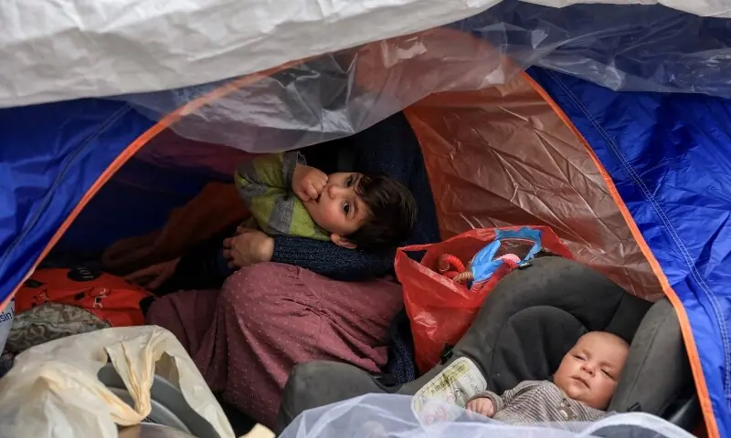 Two children of Mohammad Al Badran, a displaced Syrian from Beirut&rsquo;s southern suburbs, lie in their ten at a temporary encampment for displaced people in Beirut, Lebanon, April 1. &mdash;Reuters