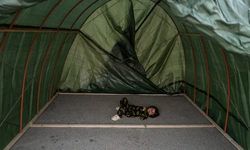 Zahra, 4, a displaced child who fled the Baalbek region following Israeli evacuation orders, lies inside a newly built tent erected by volunteers at a makeshift encampment in Beirut, Lebanon, April 15. &mdash;Reuters