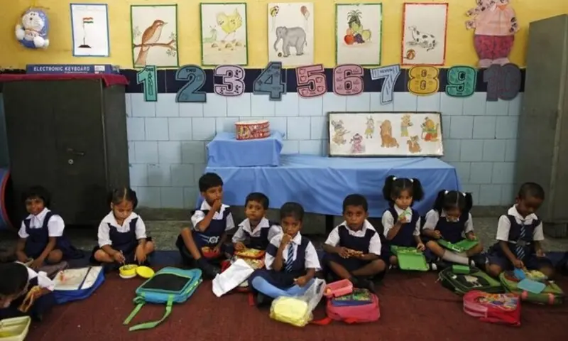 Schoolgirls eat their free mid-day meal, distributed by a government-run primary school, in New Delhi on July 5, 2013. — Reuters/File Schoolgirls eat their free mid-day meal, distributed by a government-run primary school, in New Delhi on July 5, 2013. — Reuters/File
