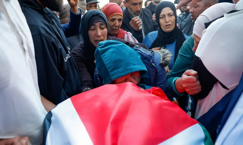 Relatives mourn over the body of a Palestinian who was killed during what Palestinians said was an Israeli settler attack in Deir Dibwan village near Ramallah, at a hospital in Ramallah, in the Israeli-occupied West Bank on April 22, 2026. &mdash; Reuters