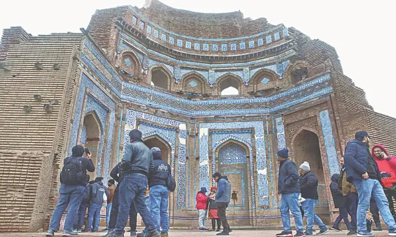 Tourists visit the tomb of Bibi Jawindi in Punjab's Uch Sharif. The monument, dating back to the 15th century, is included in the tentative list of Unesco World Heritage Sites.&mdash;APP/File