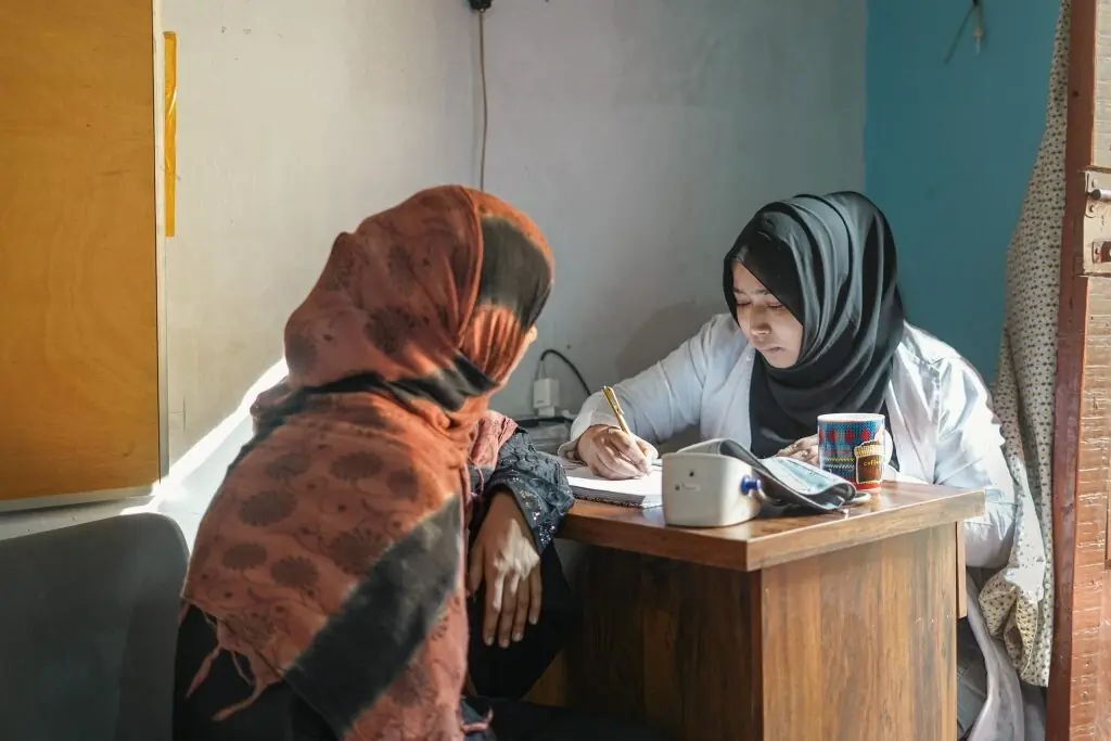 A medical professional jots down a patient&rsquo;s details at the clinic operated by the nonprofit Mama Baby Fund on Baba Island in Karachi. The clinic is the only provider of maternal, newborn and gynaecological care for women on the densely populated island &mdash;Dialogue Earth