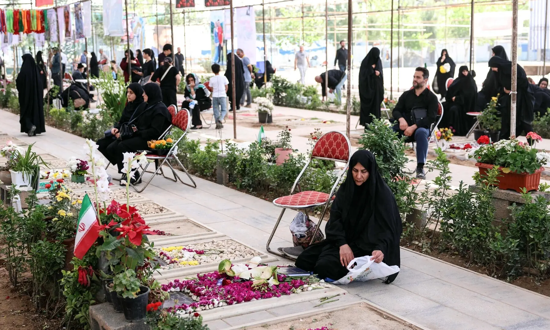 Iranians mourn at the graves of their loved ones killed during the US-Israeli war on Iran at the Behesht Zahra Cemetery in southern Tehran on April 23, 2026. &mdash; AFP