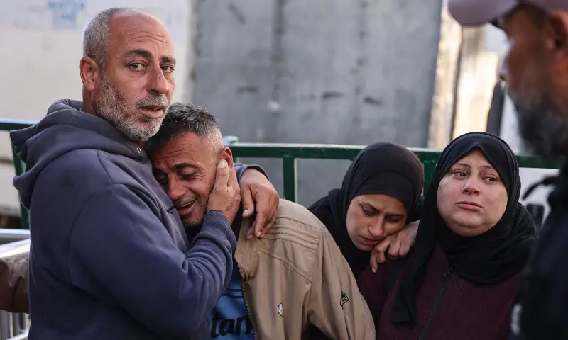 Relatives of Palestinians killed in a reported Israeli airstrike the previous night mourn during their funeral at Al-Shifa Hospital in Gaza City on April 23, 2026. &mdash; AFP