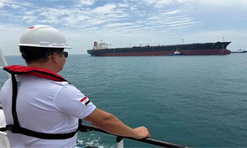 A sailor observes oil tanker HELGA, which is moored at one of Iraq&rsquo;s southern offshore oil terminals near Basra, as it prepares to load crude oil, becoming the second vessel to arrive since the closure of the Strait of Hormuz.&mdash;Reuters
