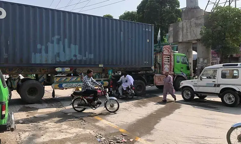 In this file photo, containers placed by police are seen blocking the Double Road, which connects Islamabad to Rawalpindi, to prevent PTI workers from entering the garrison city on September 28, 2024. &mdash; Photo by Tahir Naseer