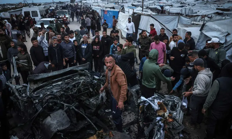 People gather at the site of an Israeli strike on a police vehicle in Khan Yunis, in the southern Gaza Strip on April 24, 2026. &mdash; AFP