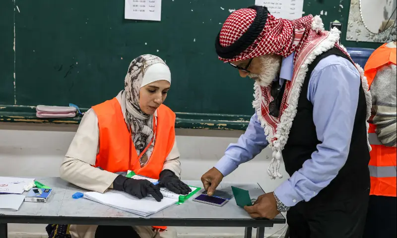 A Palestinian man registers before casting his ballot at a polling station during municipal elections in the village of al-Badhan, north of Nablus, in the Israeli-occupied West Bank on April 25, 2026. &mdash; AFP