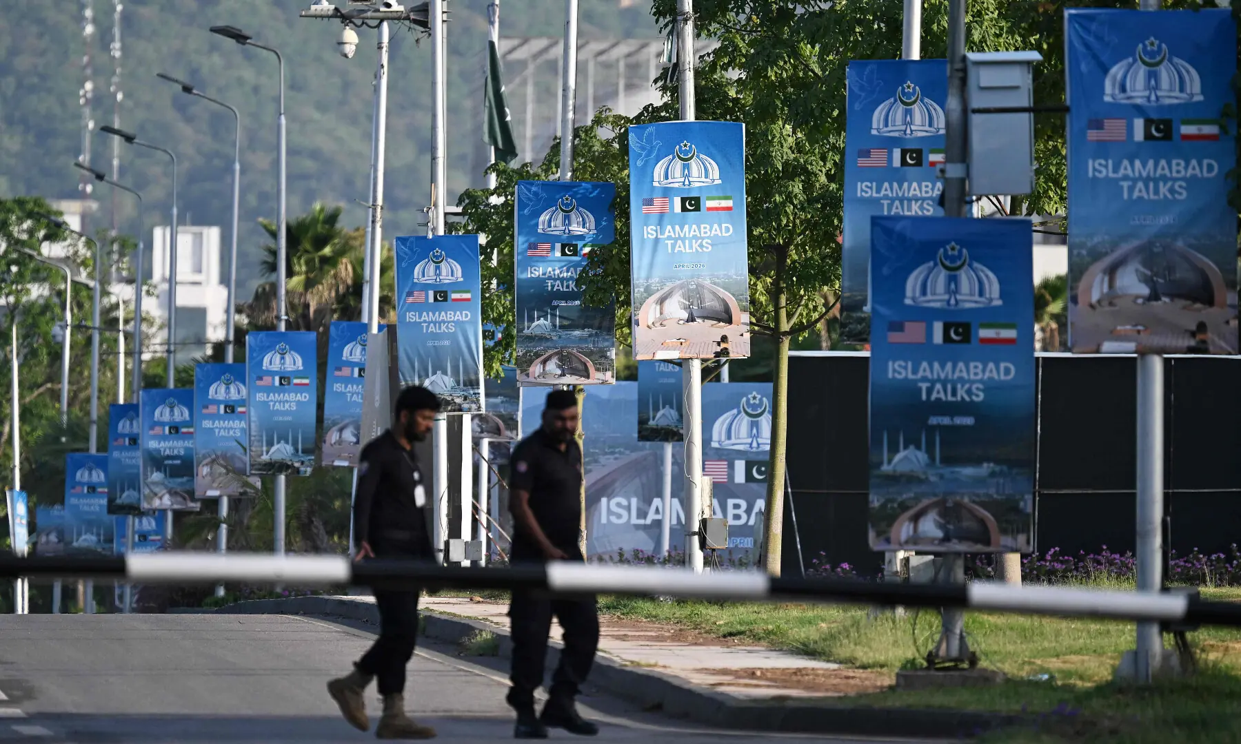 Police officers walk past posters highlighting Pakistan&rsquo;s mediation of Iran&ndash;US peace talks near the Serena Hotel at the Red Zone area in Islamabad on April 25, 2026. &mdash; AFP