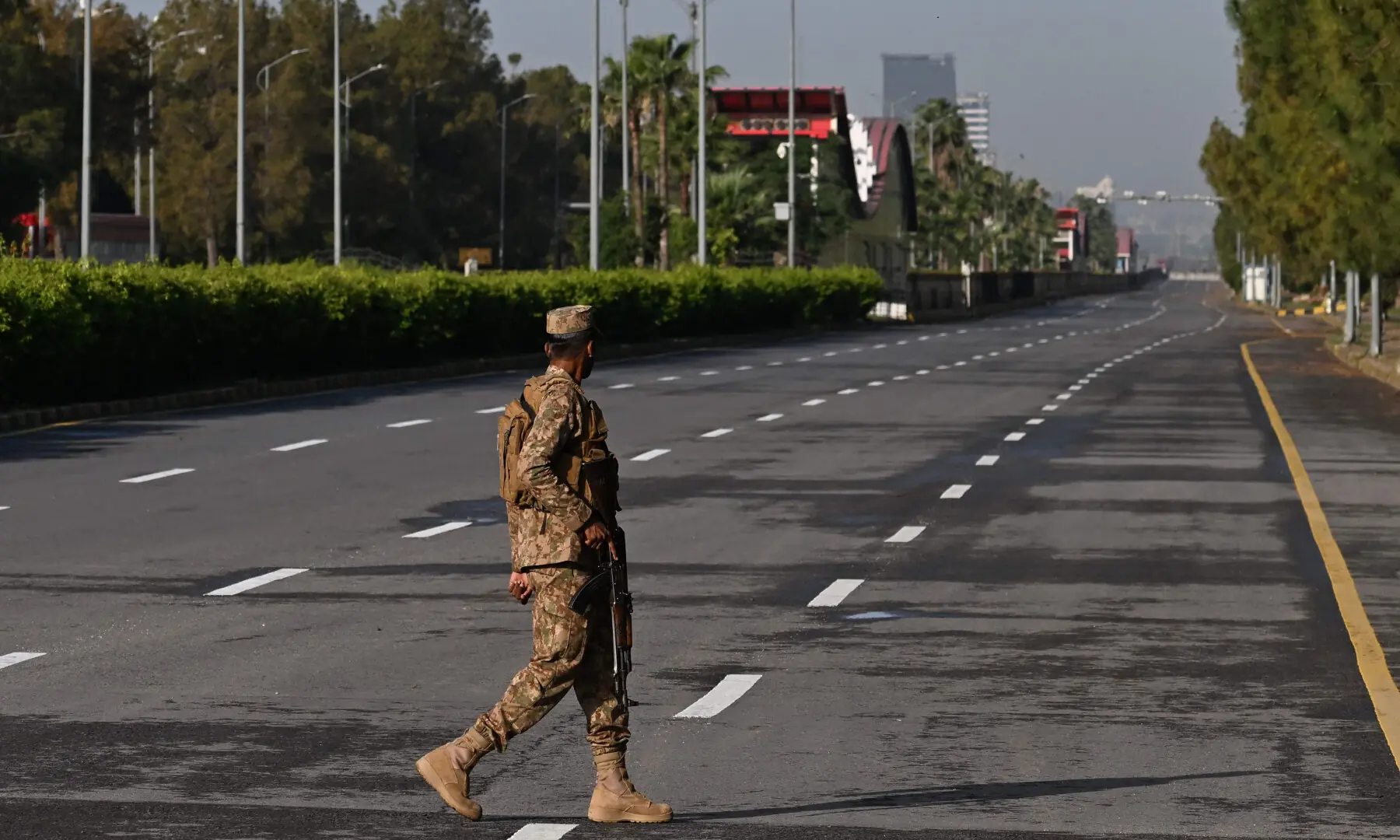 A soldier walks on a deserted street in the Red Zone area in Islamabad on April 25, 2026. &mdash; AFP