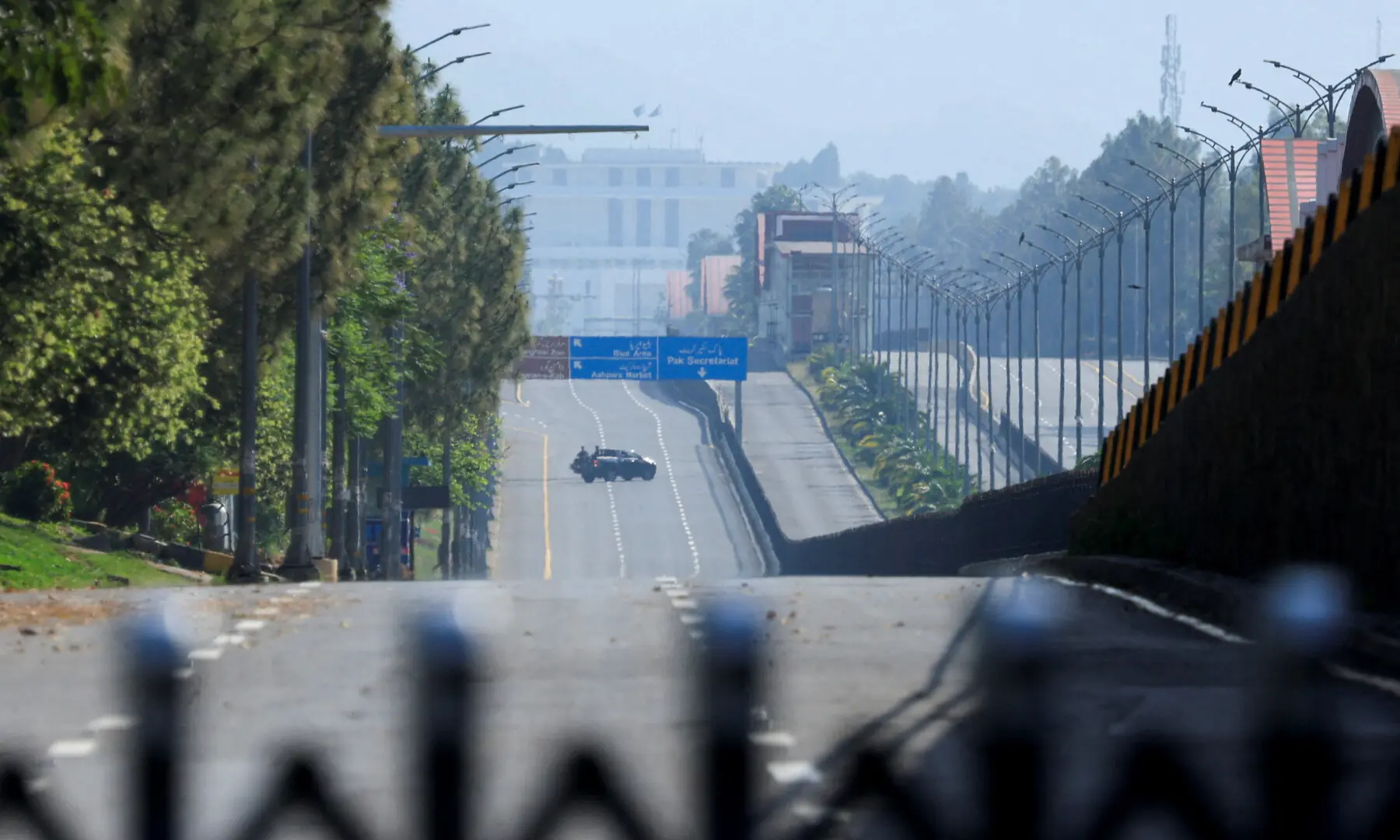 A vehicle patrols along a deserted road with the President&rsquo;s House in the background, as Pakistan prepares to host the US and Iran for the expected second phase of peace talks, in Islamabad, on April 25, 2026. &mdash; Reuters