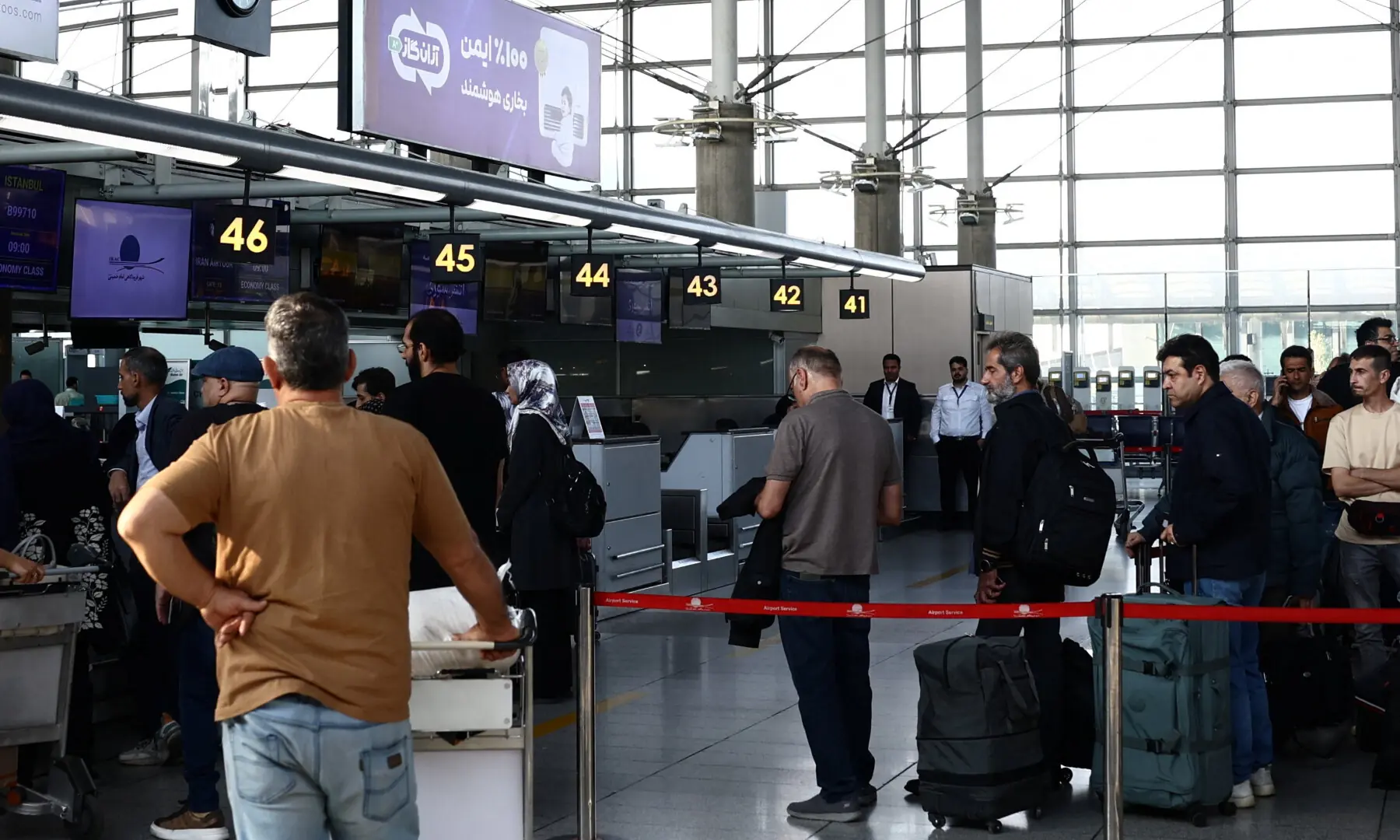 Passengers queue at the terminal hall after flights resumed at Imam Khomeini International Airport, amid a ceasefire between US and Iran, in Tehran on April 25, 2026. &mdash; WANA via Reuters