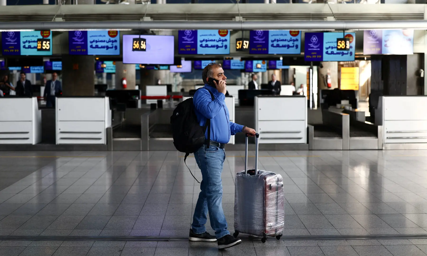 A passenger walks through the terminal hall after flights resumed at Imam Khomeini International Airport, amid a ceasefire between US and Iran, in Tehran on April 25, 2026. &mdash; WANA via Reuters