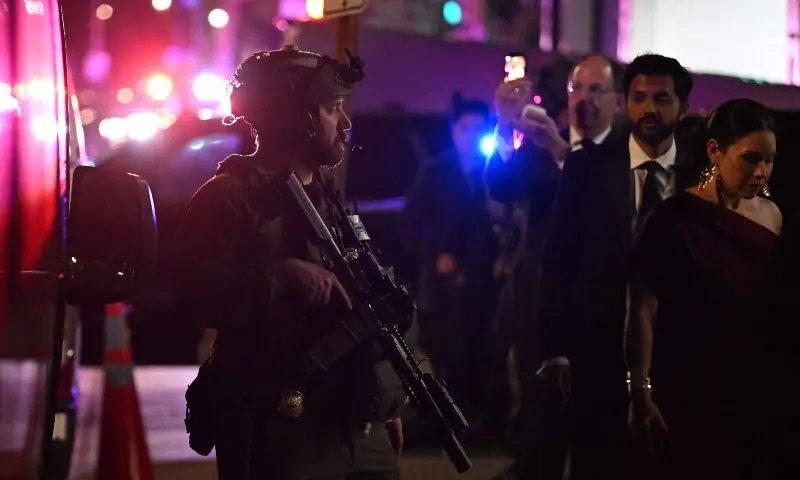 Armed commandos stand by as special guests are evacuated from the back of the Washington Hilton after shots were reportedly fired during the White House Correspondents' dinner at the Washington Hilton in Washington, DC, on April 25. &mdash; AFP