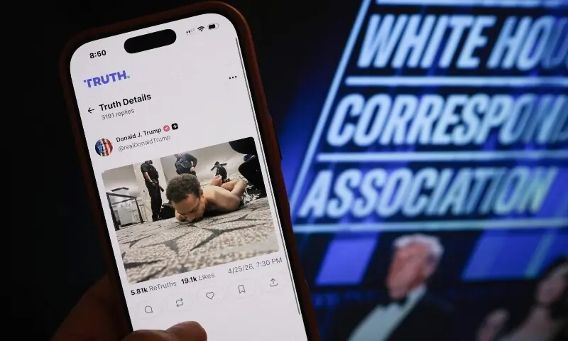 This illustration photo taken in Los Angeles shows a phone with a Truth Social post by US President Donald Trump displaying an image of the alleged suspect in a shooting incident at the White House Correspondents&rsquo; Dinner on the ground after being apprehended on April 25. &mdash; AFP