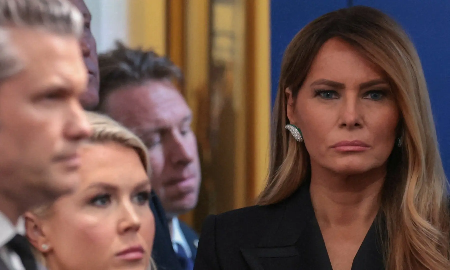 First lady Melania Trump looks on next to White House Press Secretary Karoline Leavitt and US Secretary of Defense Pete Hegseth as US President Donald Trump holds a press briefing at the White House on April 25. &mdash; Reuters