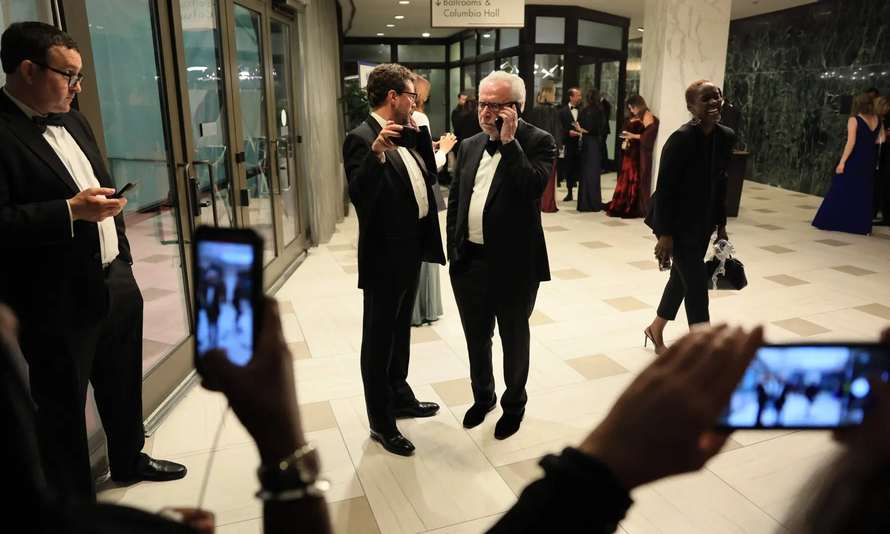 Reporters, including US journalist Wolf Blitzer (C-R), hold their phones after shots were fired during the White House Correspondents&rsquo; dinner at the Washington Hilton in Washington, DC, on April 25. &mdash; AFP