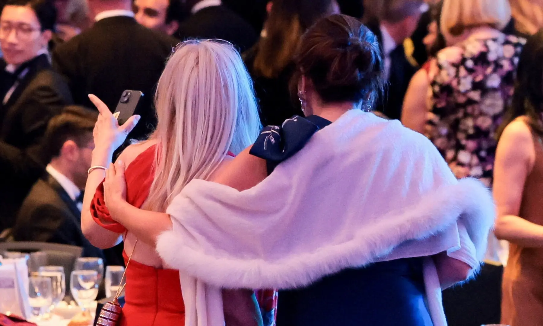 Guests embrace following a shooting incident during the annual White House Correspondents&rsquo; Association dinner in Washington, DC, US, April 25. &mdash; Reuters