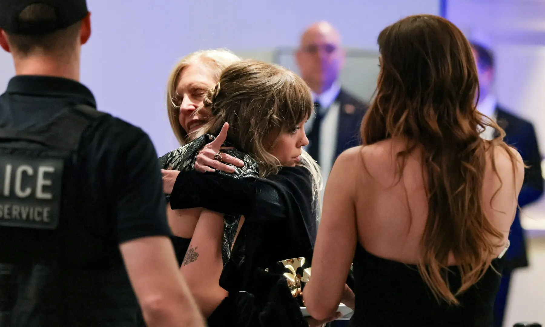 Guests embrace one another following a shooting incident during the annual White House Correspondents&rsquo; Association dinner in Washington, DC, US, April 25. &mdash; Reuters
