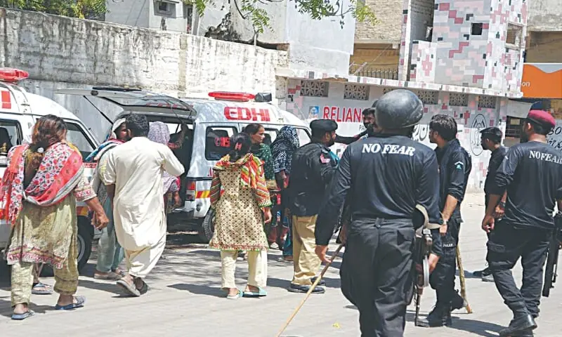 POLICE stand guard outside LUH as ambulances are parked beside a nearby Rangers post to transport victims of police firing to their villages.&mdash;Umair Ali/File