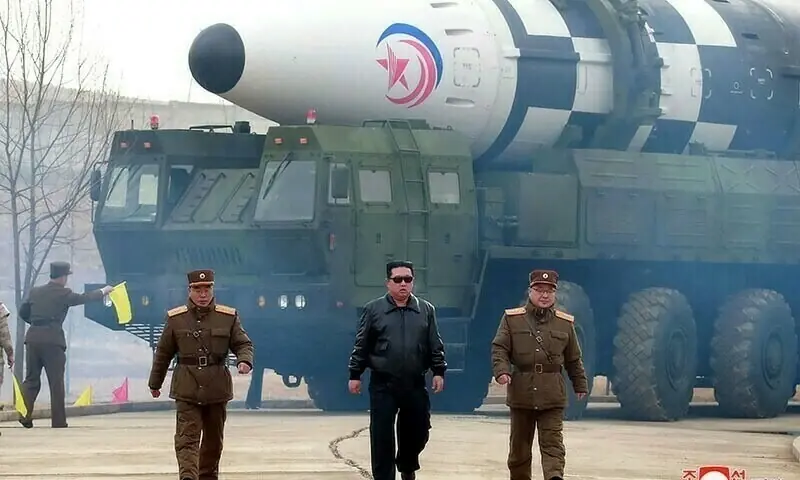 This picture released from North Korea's official Korean Central News Agency (KCNA) on March 25 shows North Korean leader Kim Jong Un (C) walking near what state media report says a new type inter-continental ballistic missile (ICBM), Hwasongpho-17 of North Korea's strategic forces before its test launch in an undisclosed location in North Korea. &mdash; AFP