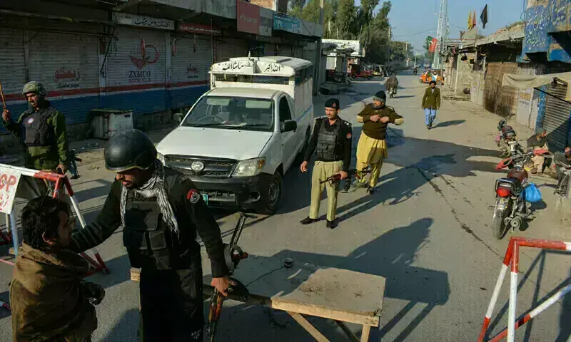 Police stand guard along a road they blocked after militants seized a police station in KP's Bannu on December 19, 2022. Photo for representation only. &mdash; AFP/File