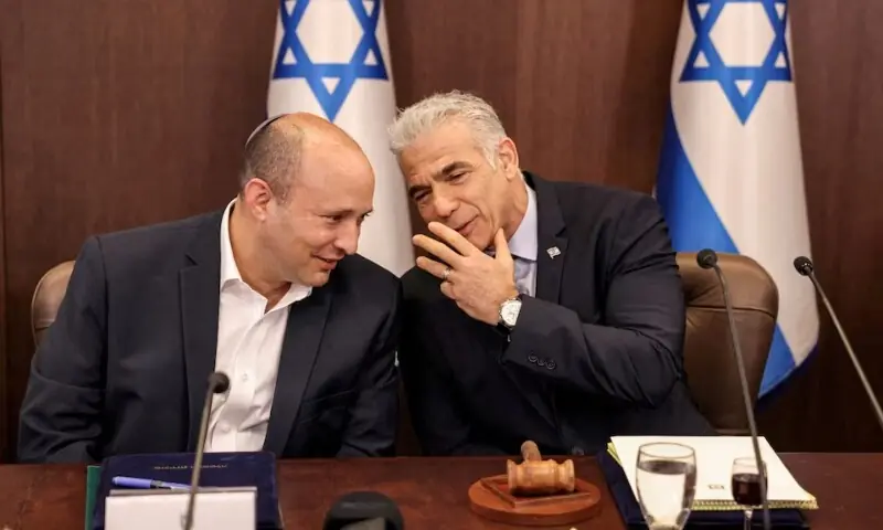 Israeli leader Yair Lapid speaks with former prime minister Naftali Bennett during the weekly cabinet meeting in Jerusalem on September 18, 2022. &mdash;Reuters/File
