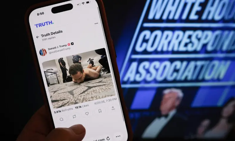 This illustration photo taken in Los Angeles shows a phone with a Truth Social post by US President Donald Trump displaying an image of the alleged suspect in a shooting incident at the White House Correspondents&rsquo; Dinner on the ground after being apprehended on April 25, 2026. &mdash; AFP
