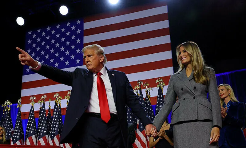 US President Donald Trump gestures as he holds hands with his wife Melania during his rally, at the Palm Beach County Convention Center in West Palm Beach, Florida, US, November 6, 2024. &mdash; Reuters/ File
