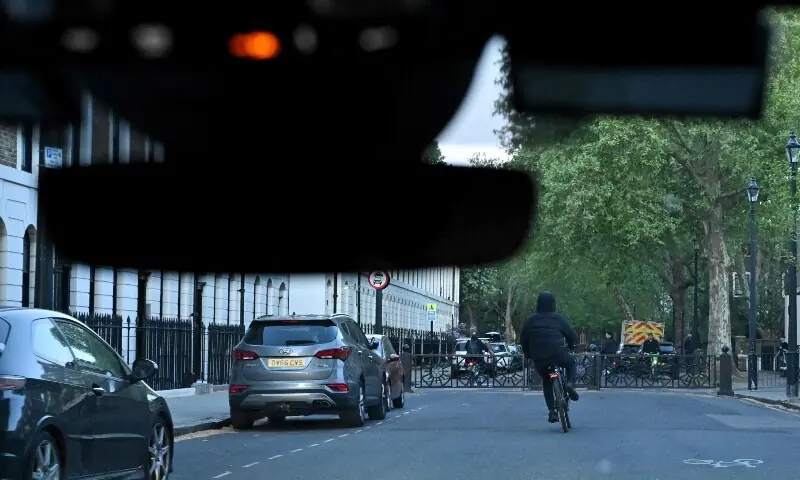 A suspect on an electric bicycle is seen from a Metropolitan Police interceptor vehicle during a patrol in central London on April 25. &mdash; AFP