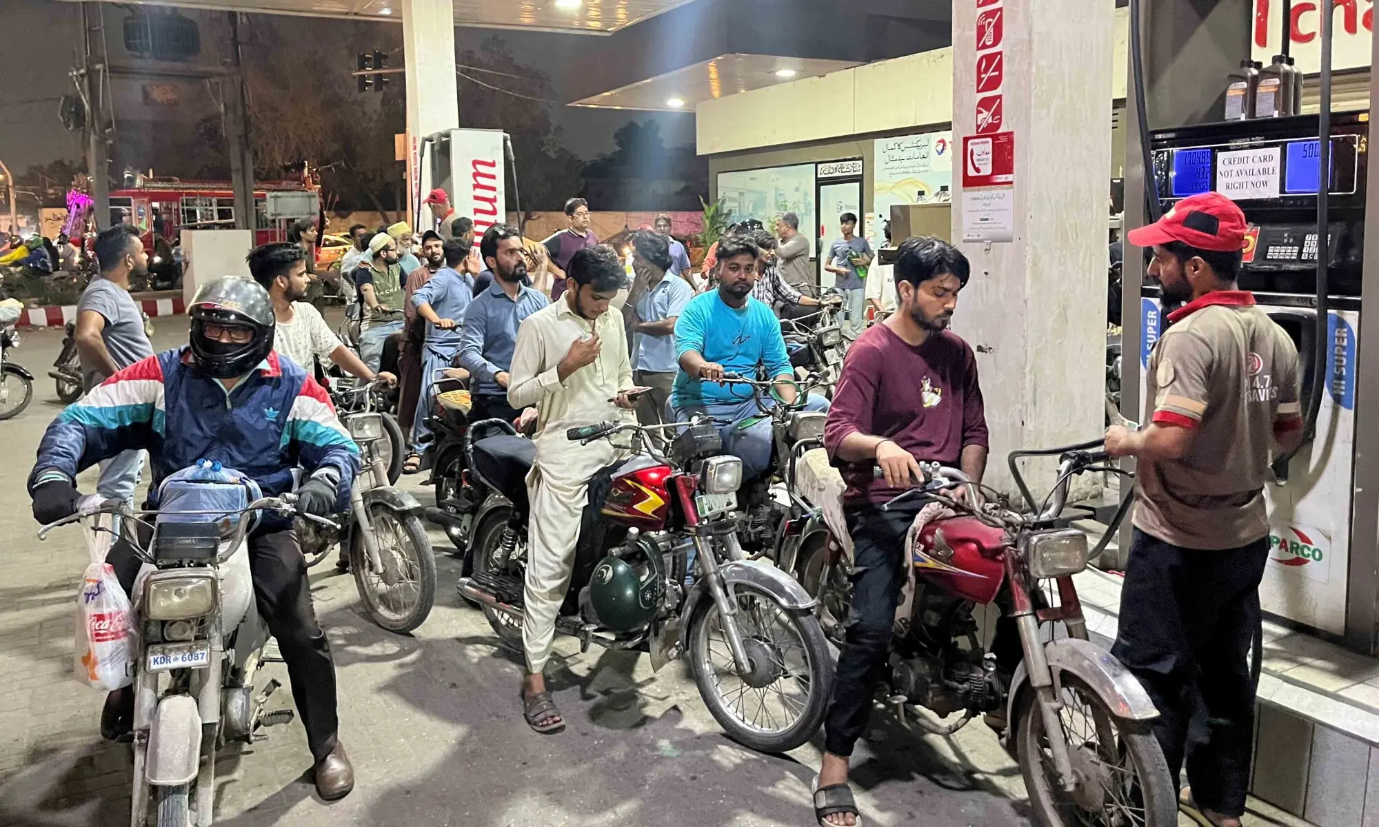 People on their motorbikes wait for their turn to get petrol in Karachi, on April 30, 2026. &mdash; Reuters