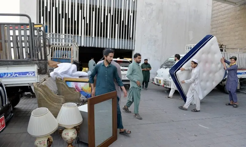 This image shows the residents of One Constitution Avenue packing up their belongings on Friday. &mdash; &mdash; Tanveer Shahzad/White Star