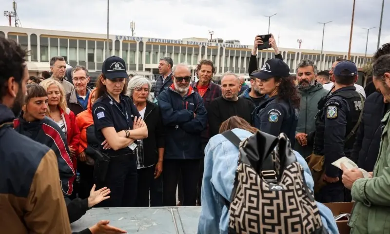Police officers watch members of the Global Sumud Flotilla vessels, intercepted by the Israeli Navy in international waters, demonstrating in the town of Ierapetra in the island of Crete, Greece, on May 1, 2026. &mdash; AFP