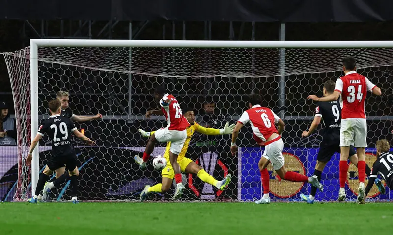 BRAGA (Portugal): Mario Dorgeles (third L) of Braga scores against Freiburg during their Europa League semi-final first leg at Estadio Municipal de Braga.&mdash;Reuters