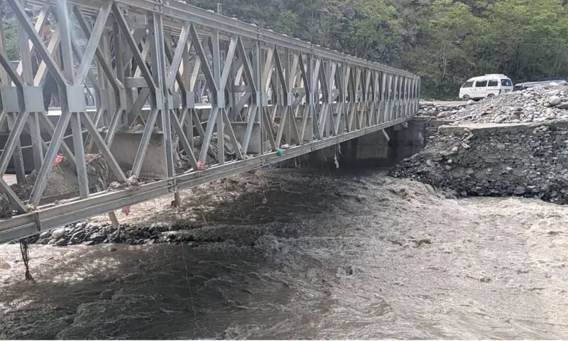 The Mahandri steel bridge installed over a stream on MNJ Road in Mansehra poses a threat to travellers due to silting and erosion. &mdash; Photo by Nisar Ahmad Khan