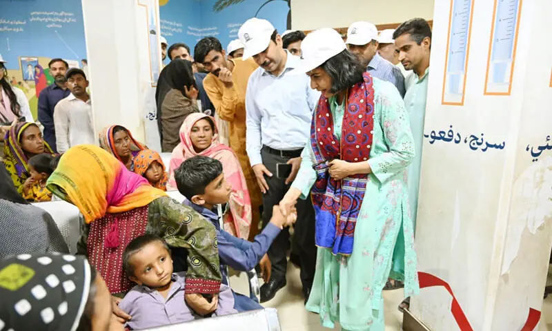 LARKANA: Shaheed Mohtarma Benazir Bhutto Medical University Vice Chancellor Prof Dr Nusrat Shah interacts with a child patient at the HIV Centre in Radodero.&mdash;Dawn