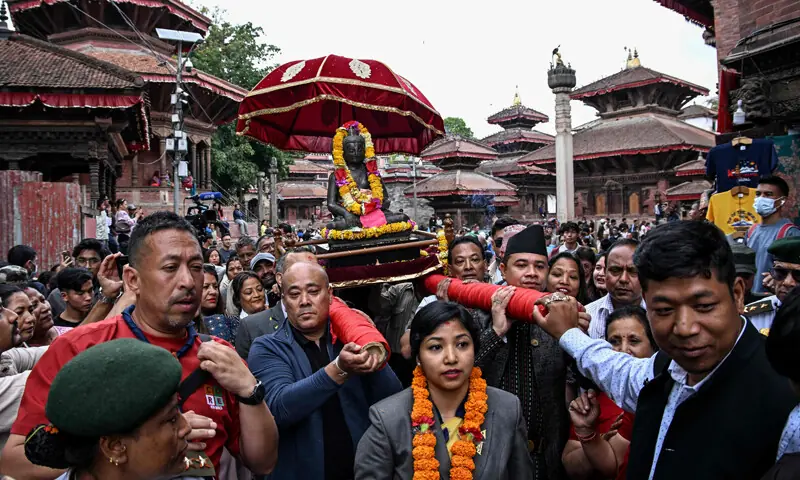 Devotees carry a Buddha statue to be reinstalled at a temple in Kathmandu.&mdash;AFP