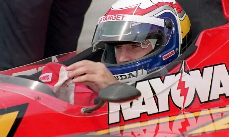 IndyCar driver Alex Zanardi of Italy adjusts his gloves during a pit stop in a qualifying run for the 15th Annual IndyCar Grand Prix in Cleveland, Ohio, the US on June 29, 1996. &mdash; AFP/File