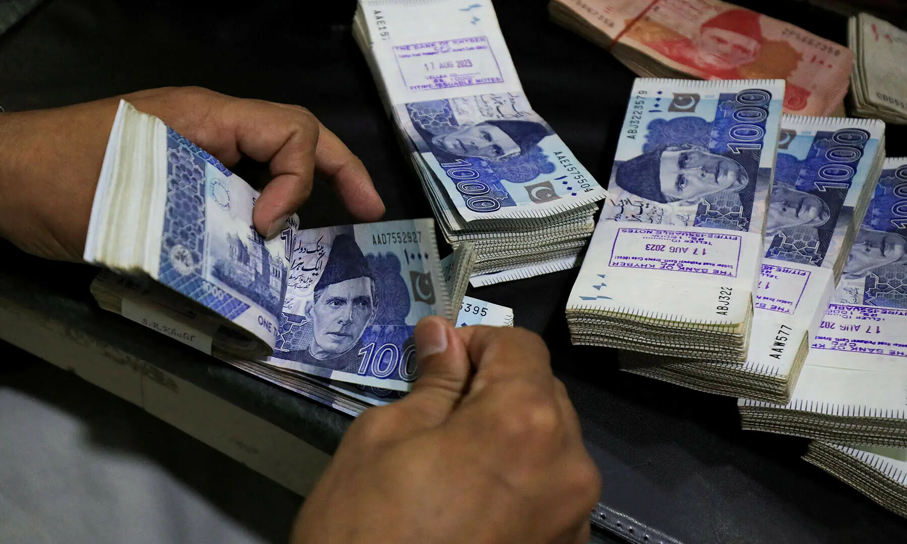 An employee counts Pakistani rupee notes at a bank in Peshawar, Pakistan August 22, 2023. &mdash; Reuters/File