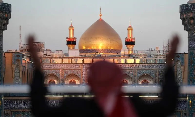 A Shia Muslim man gestures while visiting the Imam Ali Shrine during Ramazan in Najaf on March 10 amid US-Iran war. &mdash; AFP
