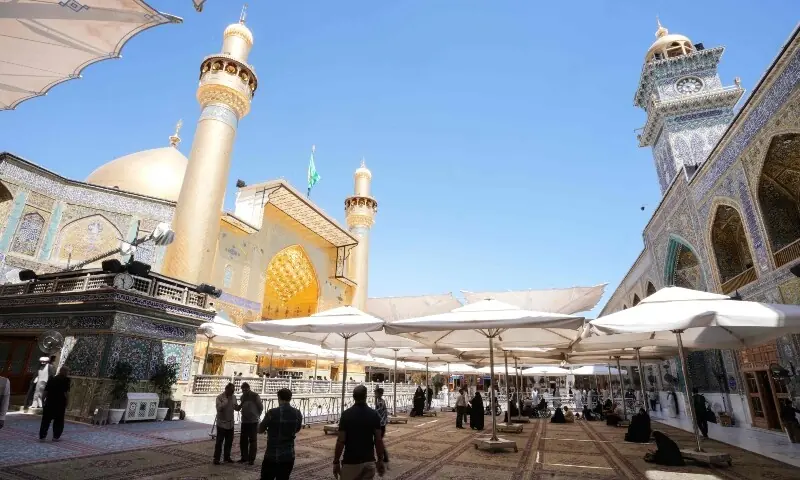 People stand inside the Imam Ali Shrine in the Old City of Najaf on April 22. &mdash; AFP