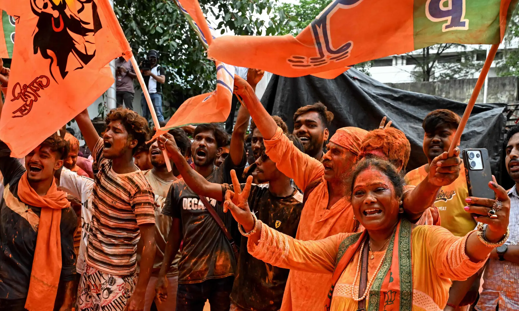 BJP supporters celebrate after taking a lead during vote counting for the West Bengal Legislative Assembly elections, near the party head office in Kolkata on May 4, 2026. &mdash; AFP